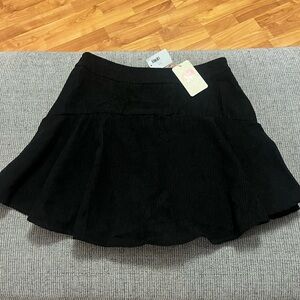 Size large black corduroy skirt Entro brand from Aniston Lane boutique with tag